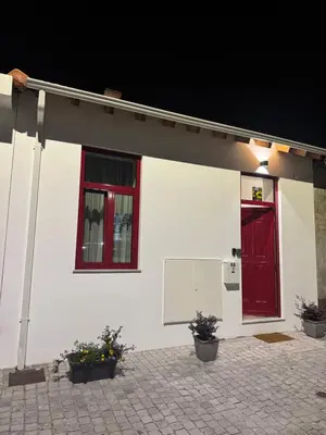 a white house with red windows and a red door at CreaConfort Casa Boa Jóia de Campanhã in Porto
