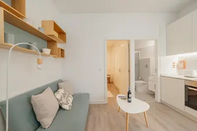 a living room with a couch and a table at Downtown Cosy Apartment by Vacationy in Porto