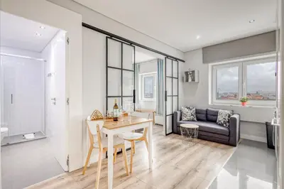 a living room with a table and a couch at Oporto Guest Green Flat in Porto