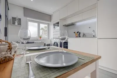 a kitchen with a table with two wine glasses on it at Oporto Guest Green Flat in Porto
