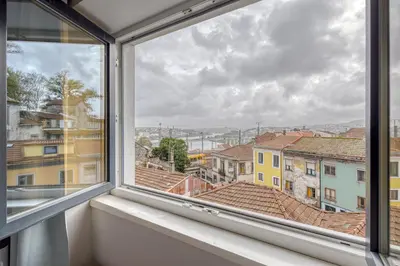 a window with a view of a city at Oporto Guest Green Flat in Porto