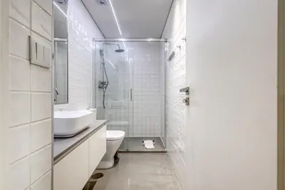 a white bathroom with a sink and a toilet at Oporto Guest Green Flat in Porto