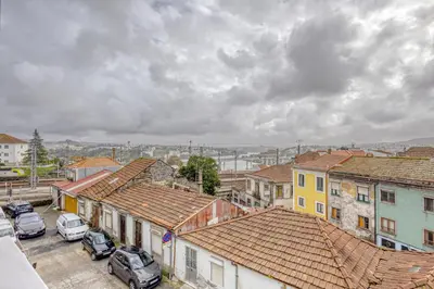 a city with cars parked in a parking lot at Oporto Guest Green Flat in Porto