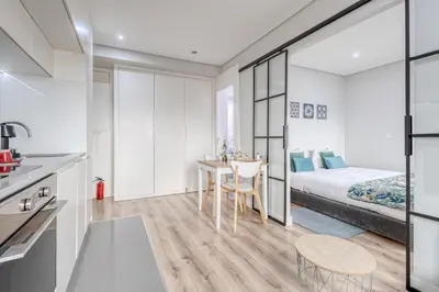 a bedroom with a bed and a table and chairs at Oporto Guest Green Flat in Porto