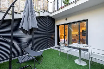 a bedroom with a bed and a living room at Nicos Garden Apartment - Porto Velho Apt in Porto