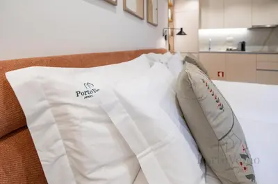 a hotel room with two towels on a bed at Nicos Garden Apartment - Porto Velho Apt in Porto