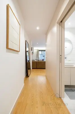 a hallway with white walls and a wooden floor at Nicos Garden Apartment - Porto Velho Apt in Porto