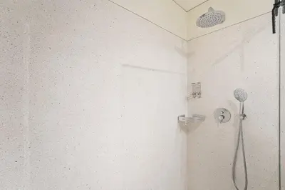 a shower in a bathroom with a shower head at DPV Residences - Studio CA/C1 in Porto