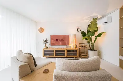 a living room with two chairs and a television at DPV Residences - Studio CA/C1 in Porto