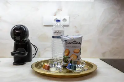 a tray with a bottle of water and some glasses at Design loft, Downtown Porto in Porto