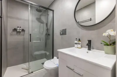a bathroom with a shower and a sink and a mirror at Design loft, Downtown Porto in Porto