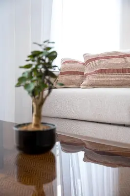 a lamp sitting on a table next to a bed at Brand new luxurious 2-Bedroom Duplex in Porto