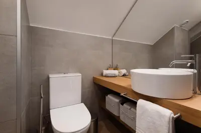 a bathroom with a white toilet and a sink at Ribeira Apartments Flores in Porto