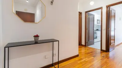 a room with a table and a mirror on the wall at Charmy Rodrigues Lobo Apartments in Porto