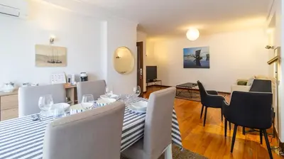 a living room with a dining table and chairs at Charmy Rodrigues Lobo Apartments in Porto