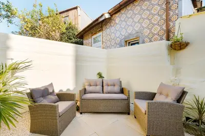 two wicker chairs sitting on a patio at GuestReady - Relaxing Place with Terrace in Porto