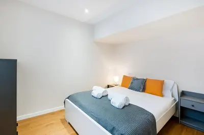 a bedroom with a white bed with two pillows at GuestReady - Relaxing Place with Terrace in Porto