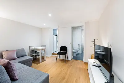 a living room with a couch and a table at GuestReady - Relaxing Place with Terrace in Porto