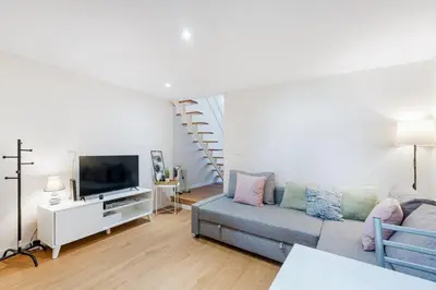 a living room with a couch and a tv at GuestReady - Relaxing Place with Terrace in Porto