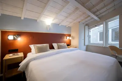 a bedroom with a large white bed and a window at Fine Arts Ateliers by Olala Homes in Porto