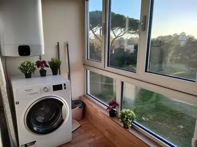 a washing machine in a room with windows at Arrábida Ruby Apartment in Vila Nova de Gaia