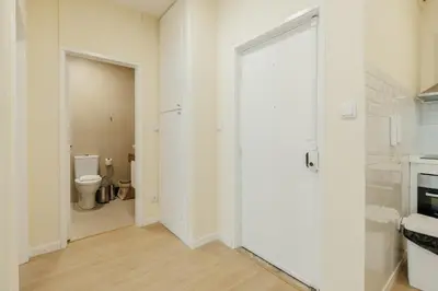 a white bathroom with a toilet and a glass door at Santa Catarina Comfort by Vacationy in Porto