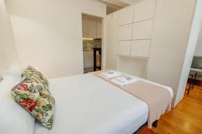 a white bed with a pillow on it in a room at Bonfim 362 by Vacationy in Porto