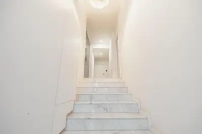 a stairway with white walls and white stairs at Rooftop Constituicao by Vacationy in Porto