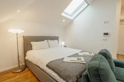 a bedroom with a bed and a couch at Rooftop Constituicao by Vacationy in Porto