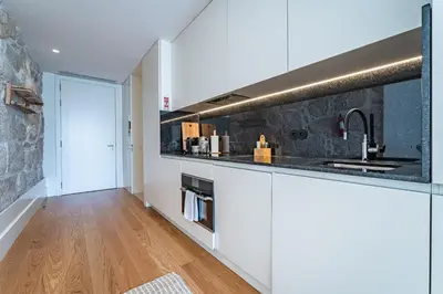 a living room with a bowl of fruit on a table at Nomads Lux - 1BD The Comfort Square in Porto in Porto