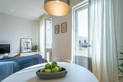 a living room with a white table and chairs at Nomads Lux - 1BD The Comfort Square in Porto in Porto