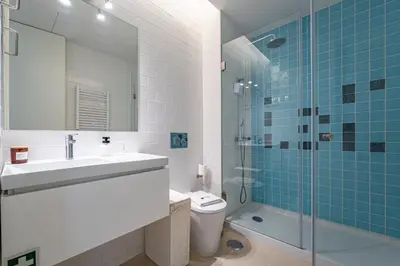 a bathroom with a toilet and a sink and a shower at Nomads Lux - 1BD The Comfort Square in Porto in Porto