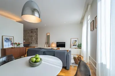 a living room with a white table and chairs at Nomads Lux - 1BD The Comfort Square in Porto in Porto