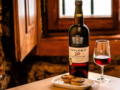 a bottle of wine next to a glass of red wine at Skyline Invicta in Porto