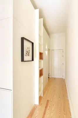 an empty hallway with white walls and wood floors at VIVA Quinta Modernista Flat in Porto