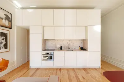 a kitchen with white cabinets in a room at VIVA Quinta Modernista Flat in Porto