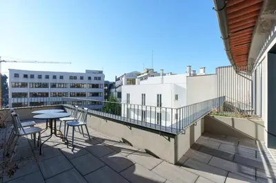 a patio with tables and chairs on a balcony at VIVA Cedofeita Serviced Apartments in Porto