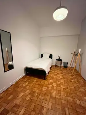 a bedroom with a bed and a wooden floor at Good end Oporto View in Porto