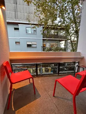 a balcony with two chairs and a red bench at Good end Oporto View in Porto