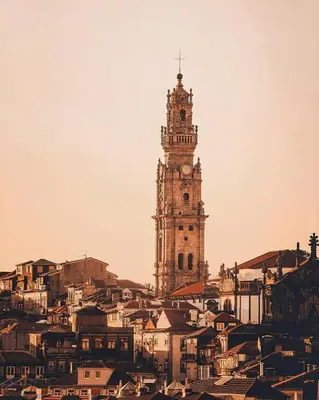 a tower with a clock on top of a city at Porto Pacific - Rua das Flores - Flower Street in Porto