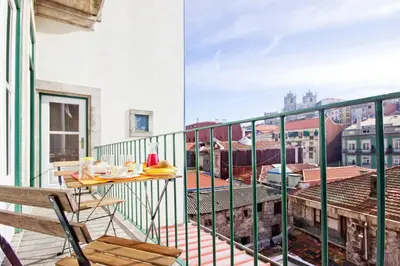 a balcony with a table and a view of a city at Porto Pacific - Rua das Flores - Flower Street in Porto