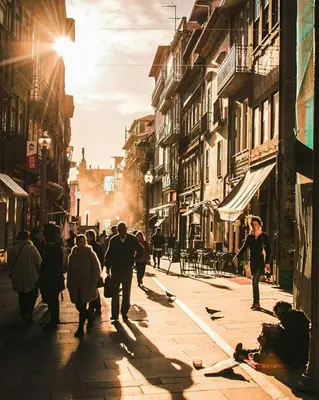 a group of people walking down a city street at Porto Pacific - Rua das Flores - Flower Street in Porto