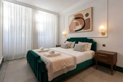 a bedroom with a large bed with towels on it at Cosy Flat in Porto with Private Patio & Garden Area by Lisbeyond in Porto