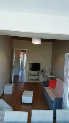 a living room with a couch and a tv at Apartamento Costa Cabral in Porto