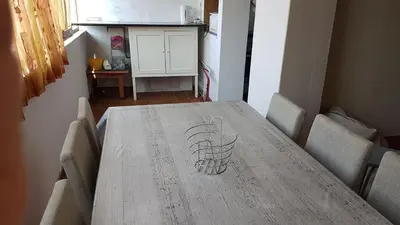 a wooden table in a kitchen with two chairs at Apartamento Costa Cabral in Porto