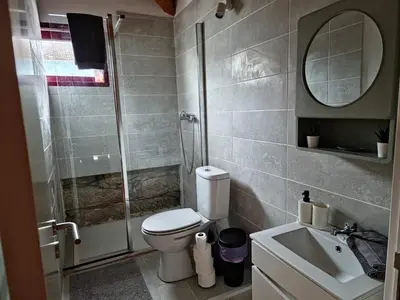 a bathroom with a shower and a toilet and a sink at Estúdio na Estação in Porto