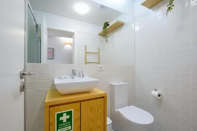 a bathroom with a sink and a toilet at 1-Bedroom Apartment with Terrace next to Bonfim Metro Station in Porto