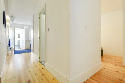 a large glass door in a room with a wooden floor at 1-Bedroom Apartment with Terrace next to Bonfim Metro Station in Porto