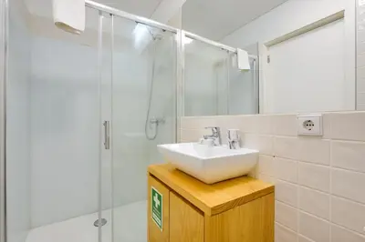 a bathroom with a sink and a shower at 1-Bedroom Apartment with Terrace next to Bonfim Metro Station in Porto