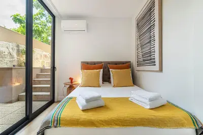 a bedroom with a white bed with pillows and a window at Heroísmo, stylish 2 bedroom apartment in Porto